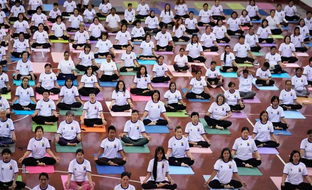 People take part in mass yoga programs to mark International Yoga Day organized by India Embassy Sunday, June 21, 2026, in Yangon, Myanmar. (AP Photo/Thein Zaw)