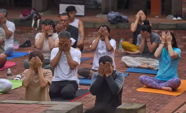 People perform yoga on International Yoga Day in Lalitpur, Nepal, Sunday, June 21, 2026. (AP Photo/Niranjan Shrestha)