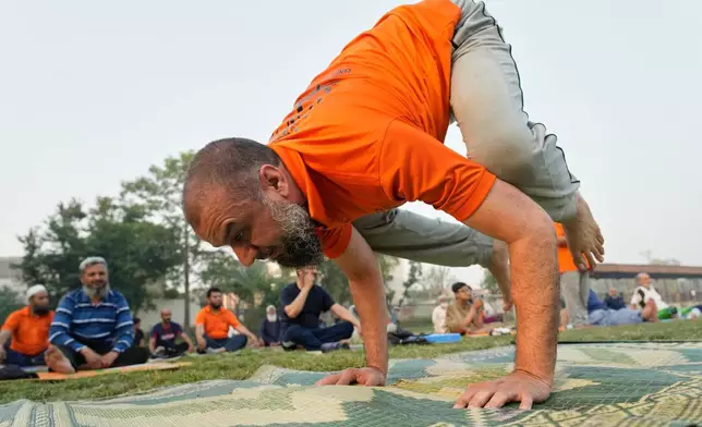 People practice yoga during a celebration of the International Yoga Day in Lahore, Pakistan, Sunday, Jun 21, 2026. (AP Photo/K.M. Chaudary)