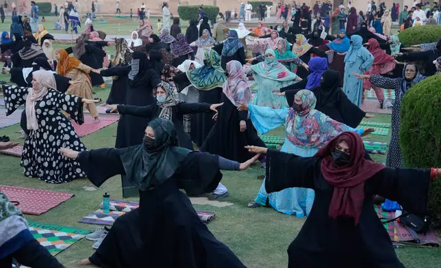 People practice yoga during a celebration of the International Yoga Day in Lahore, Pakistan, Sunday, Jun 21, 2026. (AP Photo/K.M. Chaudary)
