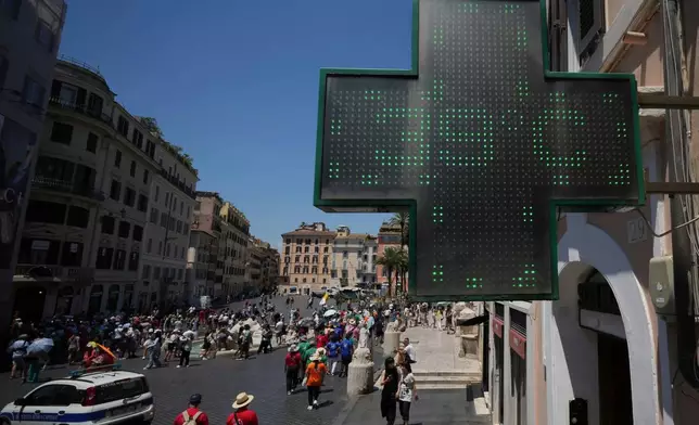 FILE - The thermometer of a drugstore shows the temperature of 39 degrees Celsius (102 degrees Fahrenheit) during a heat wave in Rome on July 1, 2025. (AP Photo/Andrew Medichini, File)