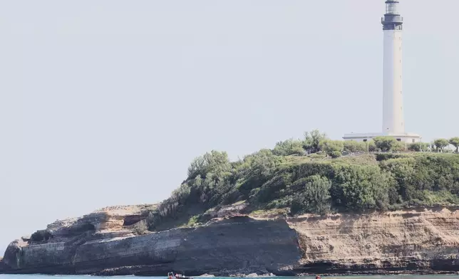 Rescue workers on boats search for a missing persona near a massive section of coastline which collapsed Wednesday evening, killing one diver and leaving another missing, in Biarritz, Thursday, June 25, 2026. (AP Photo/Yohan Bonnet)