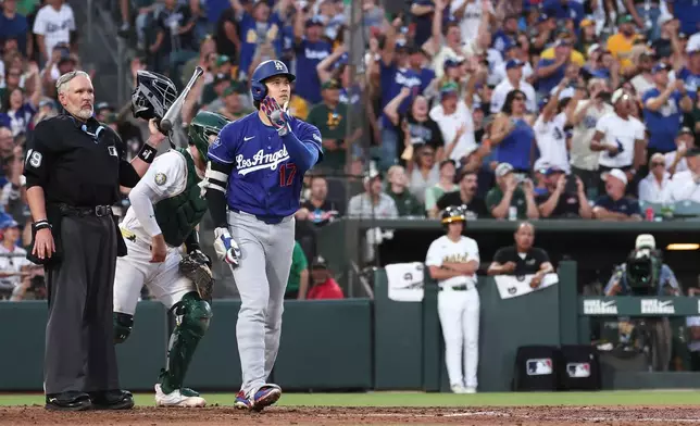 Los Angeles Dodgers' Shohei Ohtani watches after hitting a three-run home run during the sixth inning of a baseball game against the Athletics Monday, June 29, 2026, in West Sacramento, Calif. (AP Photo/Sara Nevis)