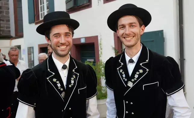 Freddie Byars from the UK and Freddie Conquer from New Zealand representing Jodler club Echo Basel as they pose outside at the Martins church in Basel, Switzerland, Saturday, June 27, 2026. (AP Photo/Jez Fielder)
