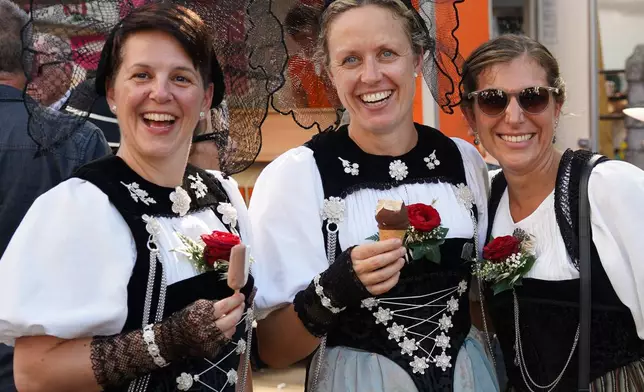 Yodeling women wear traditional clothes as they pose in Basel, Switzerland, Saturday, June 27, 2026. (AP Photo/Jez Fielder)