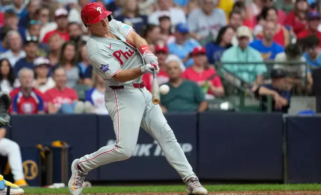 Philadelphia Phillies' J.T. Realmuto hits a three-run home run during the sixth inning of a baseball game against the Milwaukee Brewers, Saturday, June 13, 2026, in Milwaukee. (AP Photo/Aaron Gash)
