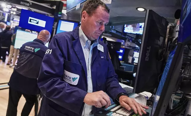 Trader Matthew Cheslock, right, works on the floor of the New York Stock Exchange, Tuesday, June 16, 2026. (AP Photo/Richard Drew)