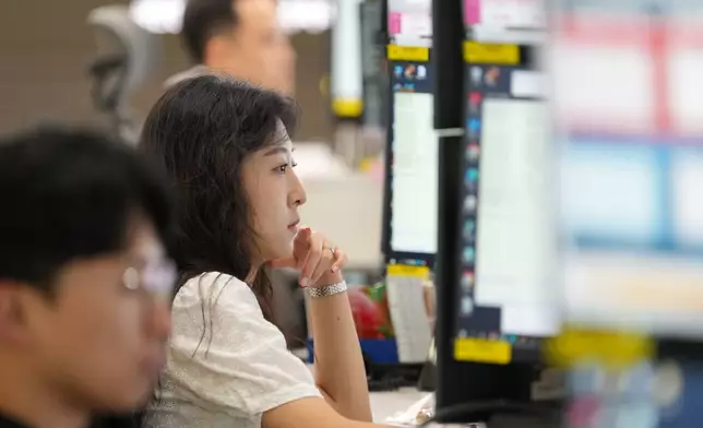 Dealers work at a dealing room of Hana Bank in Seoul, South Korea, Thursday, June 18, 2026. (AP Photo/Lee Jin-man)