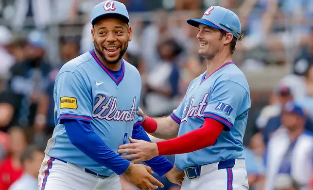 Atlanta Braves' Dominic Smith, left, reacts with teammate Mike Yastrzemski, right, after the Braves defeated the Pittsburgh Pirates in a baseball game, Saturday, June 6, 2026, in Atlanta. (AP Photo/Erik S. Lesser)