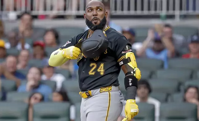 Pittsburgh Pirates designated hitter Marcell Ozuna acknowledges applause by Atlanta Braves fans during his first at-bat against the Braves during the second inning of a baseball game, Friday, June 5, 2026, in Atlanta. (AP Photo/Erik S. Lesser)