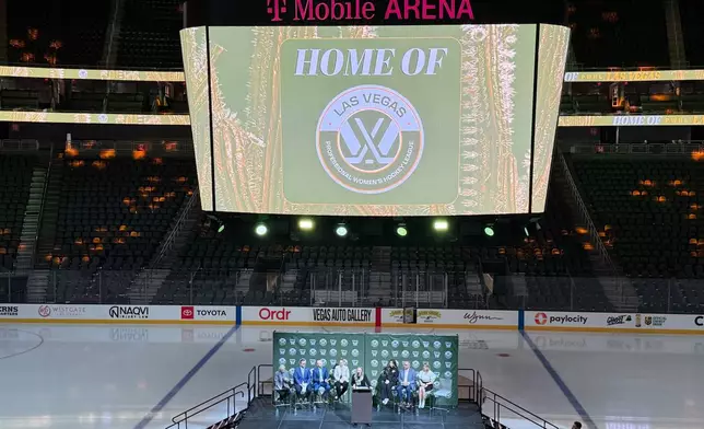 FILE - NHL Network's Jamie Hersch, center, announces the PWHL women's hockey expansion team beginning in the 2026-27 season, May 13, 2026, in Las Vegas. (AP Photo/Mark Anderson
