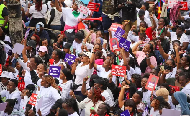 Demonstrators hold placards, during a march against rising cases of femicide, in downtown Nairobi, Kenya, Monday, June 1, 2026. (AP Photo/Patrick Ngugi)