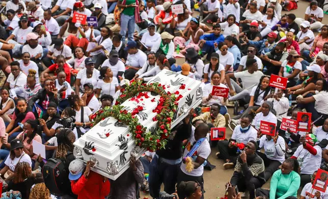 Demonstrators carry a coffin, during a march against rising cases of femicide, in downtown Nairobi, Kenya, Monday, June 1, 2026. (AP Photo/Patrick Ngugi)