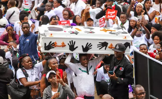 Demonstrators carry a coffin, during a march against rising cases of femicide, in downtown Nairobi, Kenya, Monday, June 1, 2026. (AP Photo/Patrick Ngugi)