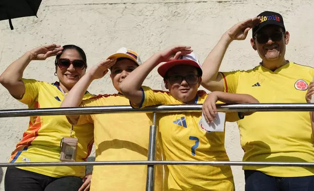 Supporters of presidential candidate Abelardo de la Espriella of the Defenders of the Motherland movement salute at the polling station where he will vote during the presidential election in Barranquilla, Colombia, Sunday, May 31, 2026. (AP Photo/Ivan Valencia)