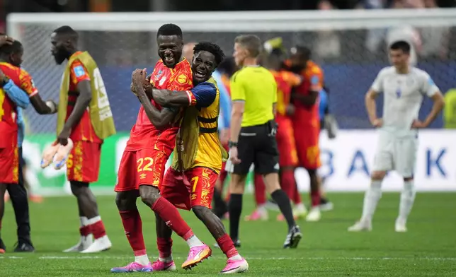 Congo's Chancel Mbemba (22) and Nathanael Mbuku (7) celebrate after the World Cup Group K soccer match between DR Congo and Uzbekistan in Atlanta, Saturday, June 27, 2026. (AP Photo/Jacob Kupferman)