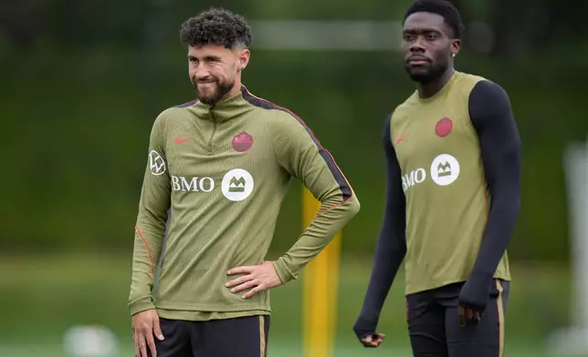 Canada's Jonathan Osorio, left, and Alphonso Davies, right, participate in a World Cup soccer training session in Vancouver, British Columbia, Thursday, June 25, 2026. (Darryl Dyck/The Canadian Press via AP)