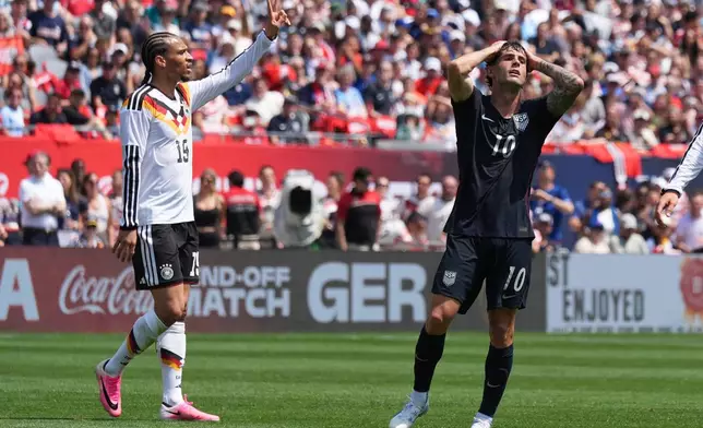United States forward Christian Pulisic, right, reacts after a missed a shot as Germany forward Leroy Sané celebrates during the first half of an international friendly soccer match in Chicago, Saturday, June 6, 2026. (AP Photo/Nam Y. Huh)
