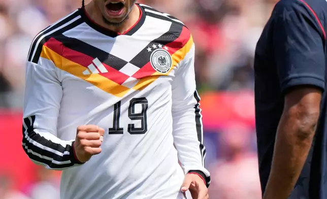 Germany forward Leroy Sané, left, celebrates after scoring a goal as United States defender Alex Freeman looks on during the second half of an international friendly soccer match in Chicago, Saturday, June 6, 2026. (AP Photo/Nam Y. Huh)