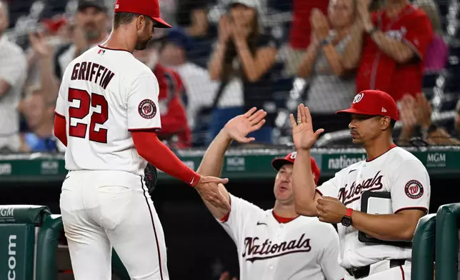 Washington Nationals starting pitcher Foster Griffin is greeted at the dugout after being taken out the game during the 8th inning of a baseball game against the Philadelphia Phillies, Monday, June 22, 2026, in Washington. (AP Photo/John McDonnell)