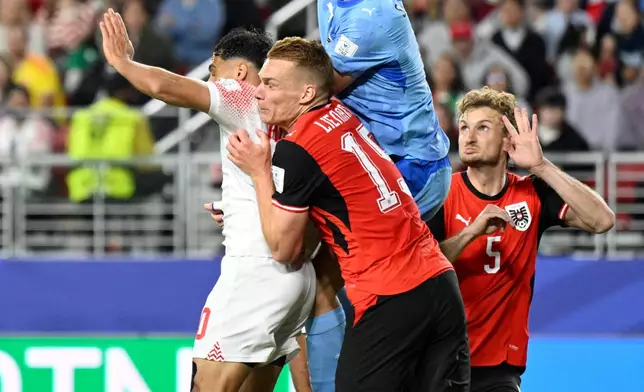 Austria goalkeeper Alexander Schlager (1) punches the ball against Jordan's Mousa Altamari (10) during the World Cup Group J soccer match between Austria and Jordan in Santa Clara, Calif., near San Francisco, Tuesday, June 16, 2026. (AP Photo/Eakin Howard)