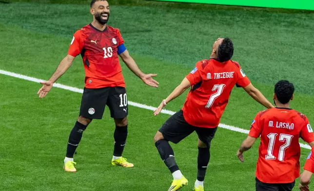 Egypt’s Trezeguet (7) celebrates his goal against New Zealand with teammate Mohamed Salah (10) during the World Cup Group G soccer match between New Zealand and Egypt in Vancouver, British Columbia, Sunday, June 21, 2026. (Timothy Matwey/The Canadian Press via AP)