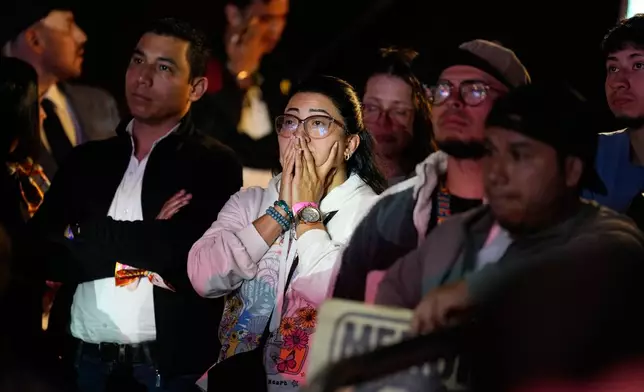 Supporters of presidential candidate Ivan Cepeda of the ruling Historic Pact coalition react to early election results after polls closed duuring the runoff election in Bogota, Colombia, Sunday, June 21, 2026. (AP Photo/Fernando Vergara)