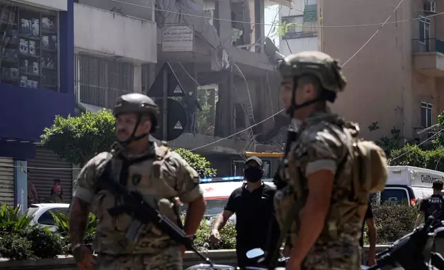 Lebanese soldiers stand guard at the site of an Israeli airstrike that struck an apartment in Dahiyeh, Beirut's southern suburbs, Lebanon, Sunday, June 14, 2026. (AP Photo/Bilal Hussein)