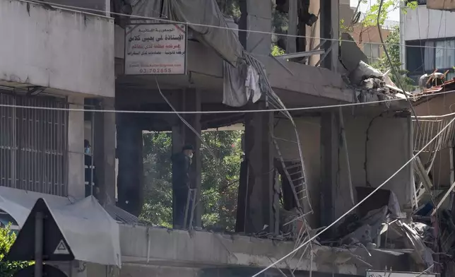 A man checks an apartment that was hit in an Israeli airstrike in Dahiyeh, Beirut's southern suburbs, Lebanon, Sunday, June 14, 2026. (AP Photo/Bilal Hussein)