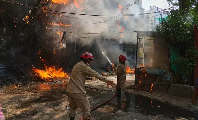 Firefighters douse a fire in a hotel in New Delhi, India, Wednesday, June 3, 2026. (AP Photo/Manish Swarup)