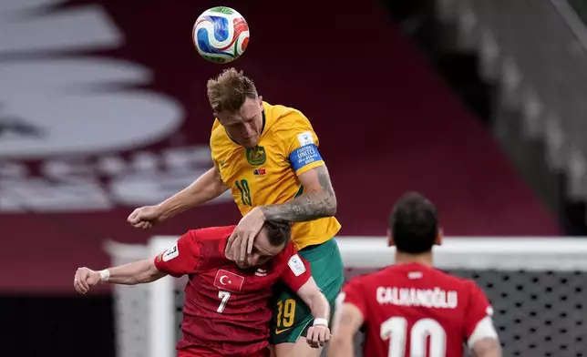 Australia's Harry Souttar center, challenges for the ball with Turkey's Muhammed Kerem Akturkoglu, during the World Cup Group D soccer match between Australia and Turkey in Vancouver, Canada, Saturday, June 13, 2026. (Ethan Cairns/The Canadian Press via AP)