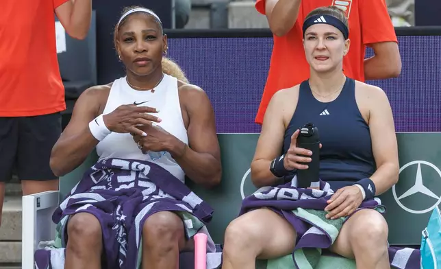 Serena Williams, left, and Karolina Muchova sit on the bench during their first round women doubles tennis match against Routliffe and Olmos, in Berlin, Germany, Tuesday June 16, 2026. (Andreas Gora/dpa via AP)