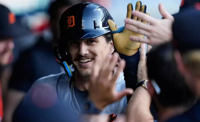 Detroit Tigers' James Outman is congratulated in the dugout after hitting a home run in the third inning of a baseball game against the Cleveland Guardians in Cleveland, Friday, June 12, 2026. (AP Photo/Sue Ogrocki)