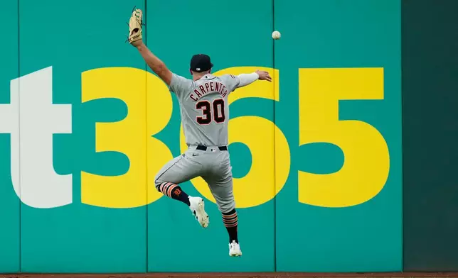 Detroit Tigers right fielder Kerry Carpenter (30) can't get to a ball hit for a double by Cleveland Guardians' Angel Martínez in the sixth inning of a baseball game in Cleveland, Friday, June 12, 2026. (AP Photo/Sue Ogrocki)