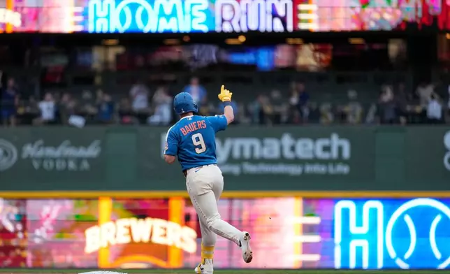 Milwaukee Brewers' Jake Bauers rounds the bases after hitting a three-run home run during the fifth inning of a baseball game against the Philadelphia Phillies, Friday, June 12, 2026, in Milwaukee. (AP Photo/Aaron Gash)