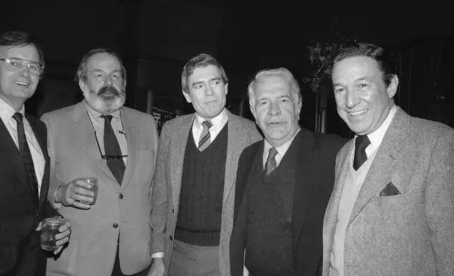 FILE - Dan Rather, center, joined by Harry Reasoner, second from right, and Mike Wallace, right, celebrates his first anniversary as anchorman and managing editor of the CBS Evening News, at a restaurant in New York, March 9, 1982. (AP Photo/Nancy Kaye, File)