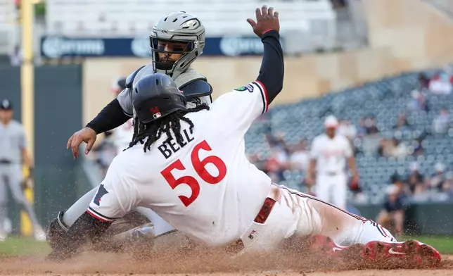 Chicago White Sox catcher Edgar Quero, top, tags out Minnesota Twins' Josh Bell (56) at home plate during the fourth inning of a baseball game, Monday, June 1, 2026, in Minneapolis. (AP Photo/Matt Krohn)