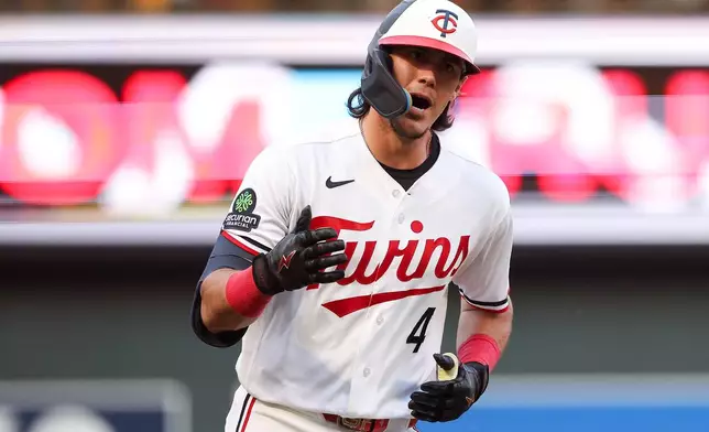 Minnesota Twins' Tristan Gray celebrates after his grand slam against the Chicago White Sox during the fourth inning of a baseball game, Monday, June 1, 2026, in Minneapolis. (AP Photo/Matt Krohn)