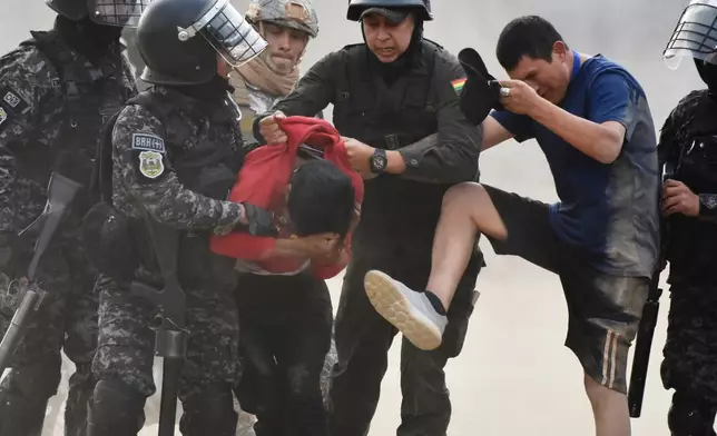Police detain demonstrators during an anti-government protest in Vinto, Bolivia, Monday, June 8, 2026. (AP Photo/Dico Soliz)
