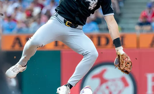 Philadelphia Phillies' J.T. Realmuto (10) is safe on a steal at second as Chicago White Sox shortstop Colson Montgomery (12) leaps for the ball in the sixth inning of a baseball game, Saturday, June 6, 2026, in Philadelphia. (AP Photo/Laurence Kesterson)