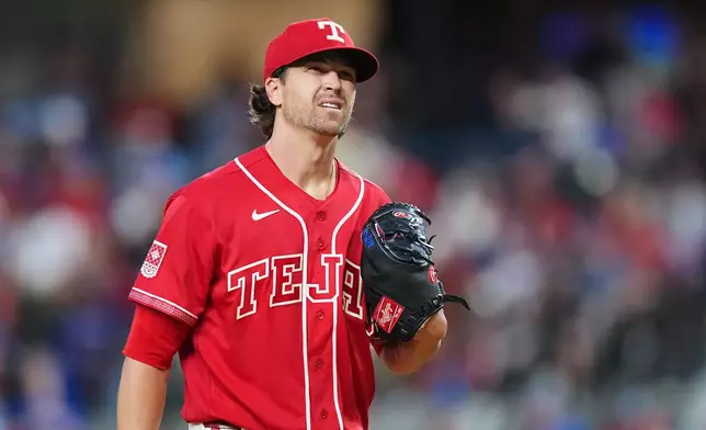 Texas Rangers starting pitcher Jacob Degrom reacts between pitches to the San Diego Padres during the first inning of a baseball game, Friday, June 19, 2026 in Arlington, Texas. (AP Photo/Julio Cortez)