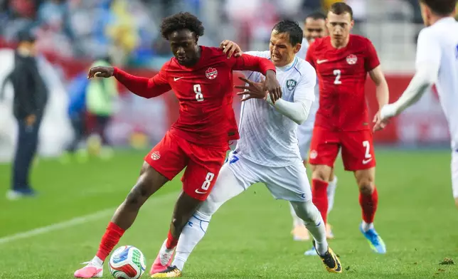 Canada's Ismael Kone (8) and Uzbekistan's Otabek Shukurov, second from left, vie for the ball during the first half of an international friendly soccer match in Edmonton, Alberta, Monday, June 1, 2026. (Codie McLachlan/The Canadian Press via AP)