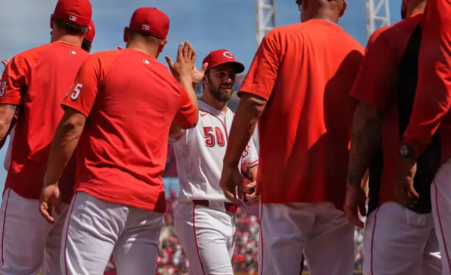 Cincinnati Reds pitcher Sam Moll is greeted as he walks off the field after winning a baseball game against the Atlanta Braves in Cincinnati, Sunday, May 31, 2026. (AP Photo/Carolyn Kaster)