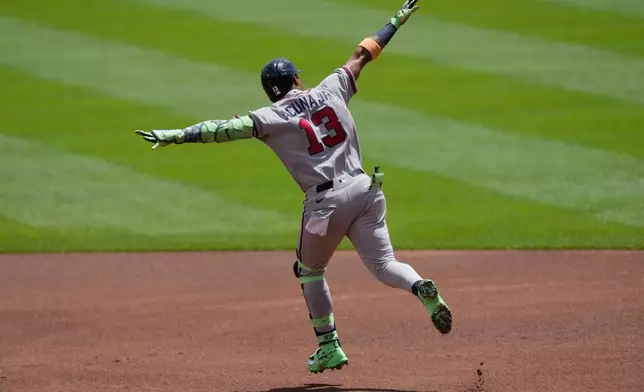Atlanta Braves' Ronald Acuña Jr. celebrates as he rounds the bases after hitting a solo home run during the first inning of a baseball game against the Cincinnati Reds in Cincinnati, Sunday, May 31, 2026. (AP Photo/Carolyn Kaster)