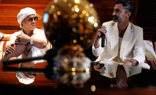 Brazilian football legend Ronaldinho, left, listens as Giorgio Mallone, Ravenna FC creative director, talks about the team's new kit during a media event celebrating Ronaldinho's recent signing with the Italian soccer club, at Cipriani Downtown Miami restaurant, Tuesday, June 23, 2026, in Miami. (AP Photo/Rebecca Blackwell)