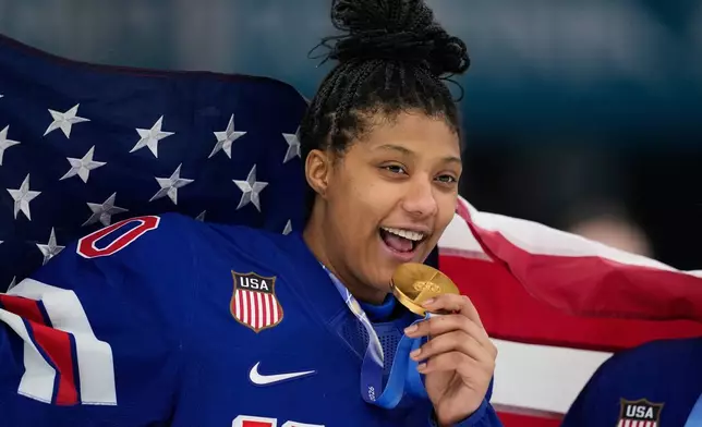 FILE - United States' Laila Edwards (10) poses after the United States' women's ice hockey team was presented with the gold medals at the 2026 Winter Olympics, in Milan, Italy, Feb. 19, 2026. (AP Photo/Petr David Josek, File)