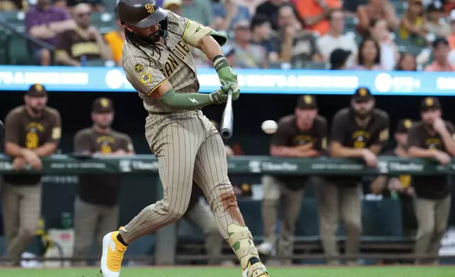 San Diego Padres' Fernando Tatis Jr. hits a single off Baltimore Orioles pitcher Shane Baz which scored Ty France during the second inning of a baseball game, Friday, June 12, 2026, in Baltimore. (AP Photo/Terrance Williams)