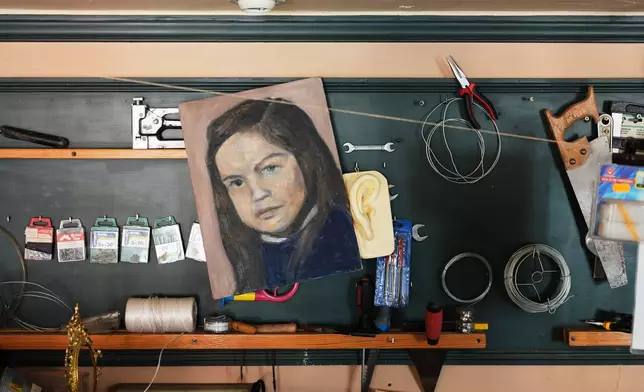 A childhood self-portrait by Paula Alonso hangs in the studio of her apartment in Madrid, Spain, Thursday, May 21, 2026. (AP Photo/Bernat Armangue)