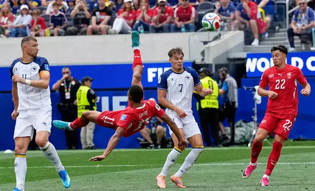 Switzerland's Dan Ndoye (11) attemps an overhead kick during the World Cup Group B soccer match between Switzerland and Bosnia in Inglewood, Calif, near Los Angeles, Thursday, June 18, 2026. (AP Photo/Gregory Bull)