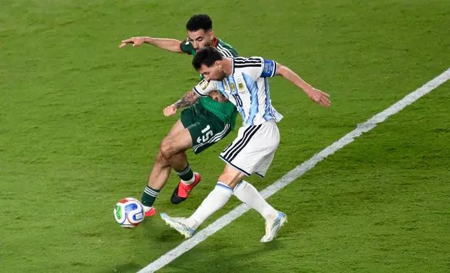 Argentina's Lionel Messi (10) shoots against Algeria's Rayan Ait-Nouri (15) during the World Cup Group J soccer match between Argentina and Algeria in Kansas City, Mo., Tuesday, June 16, 2026. (AP Photo/Reed Hoffmann)